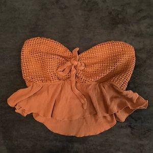 Strapless burnt orange crop top.
